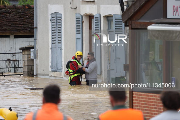 Firefighters are rescuing people after a huge storm in Narcy, France, on June 20, 2024. 