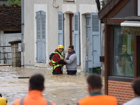 Firefighters are rescuing people after a huge storm in Narcy, France, on June 20, 2024. (