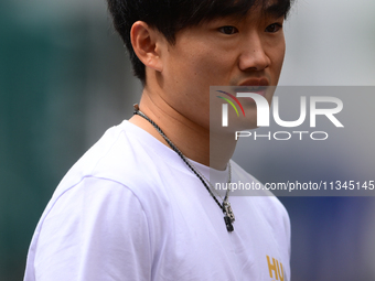 Yuki Tsunoda of Visa Cash-Up Racing Bulls is arriving into the paddock during Thursday media day of the Spanish GP, the 10th round of the Fo...