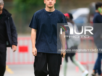 Guanyu Zhou of Stake F1 Team KICK Sauber is arriving into the paddock during Thursday media day of the Spanish GP, the 10th round of the For...