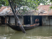 A man is coming out with his boat from his partially submerged house in flood waters in Companiganj, Sylhet, Bangladesh, on Thursday, June 2...