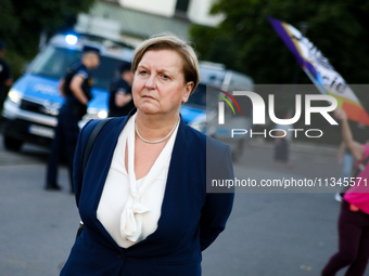 Anna Fotyga, a member of the European Parliament, is walking past the activists during a protest against Jaroslaw Kaczynski's monthly arriva...