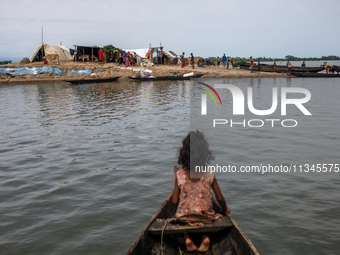 Local residents are taking temporary shelter in elevated areas during flooding in Companiganj, Sylhet, Bangladesh, on Thursday, June 20, 202...