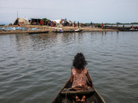 Local residents are taking temporary shelter in elevated areas during flooding in Companiganj, Sylhet, Bangladesh, on Thursday, June 20, 202...