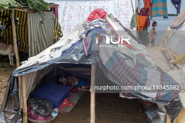 Local residents are taking temporary shelter in elevated areas during flooding in Companiganj, Sylhet, Bangladesh, on Thursday, June 20, 202...