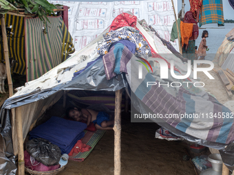 Local residents are taking temporary shelter in elevated areas during flooding in Companiganj, Sylhet, Bangladesh, on Thursday, June 20, 202...