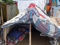 Local residents are taking temporary shelter in elevated areas during flooding in Companiganj, Sylhet, Bangladesh, on Thursday, June 20, 202...