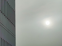 Sun close to a building setting behind haze is seen in L’Aquila, Italy, on June 19th, 2024. High atmospheric pressure from Africa (african a...