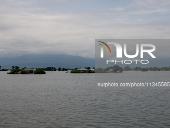 Houses are being seen partially submerged in Companiganj, Sylhet, Bangladesh, on June 20, 2024. In Sylhet, lashing rain and rivers swollen b...