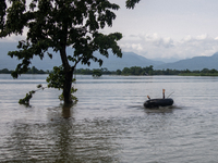 A child is playing with a raft in floodwater in Companiganj, Sylhet, Bangladesh, on Thursday, June 20, 2024. In Sylhet, lashing rain and riv...