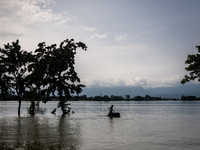 A child is riding a raft in floodwater in Companiganj, Sylhet, Bangladesh, on Thursday, June 20, 2024. In Sylhet, lashing rain and rivers sw...