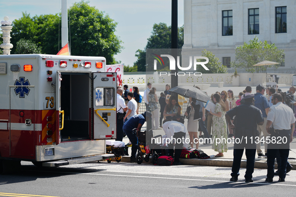 An elderly man is fainting in front of the Supreme Court today as temperatures in Washington, DC, are reaching into the 90s. The court is is...