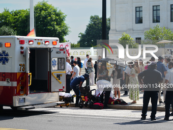 An elderly man is fainting in front of the Supreme Court today as temperatures in Washington, DC, are reaching into the 90s. The court is is...