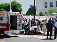 An elderly man is fainting in front of the Supreme Court today as temperatures in Washington, DC, are reaching into the 90s. The court is is...