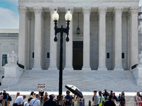 An elderly man is fainting in front of the Supreme Court today as temperatures in Washington, DC, are reaching into the 90s. The court is is...