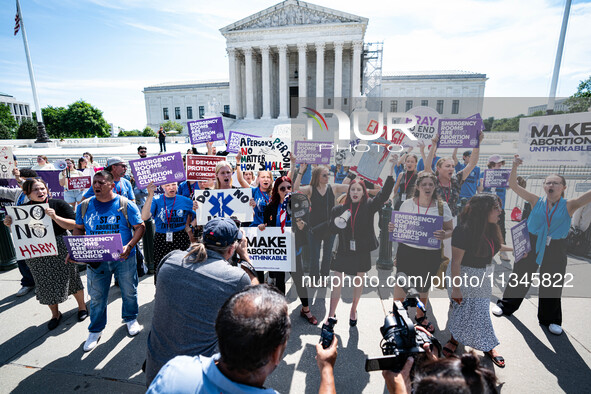 About a dozen pro-life activists are gathering outside the US Supreme Court in Washington, DC, on June 20, 2024, as they await a decision in...