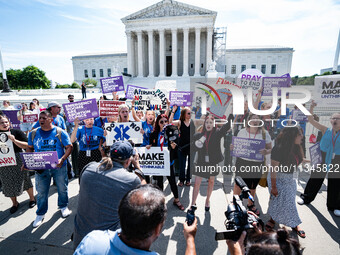 About a dozen pro-life activists are gathering outside the US Supreme Court in Washington, DC, on June 20, 2024, as they await a decision in...