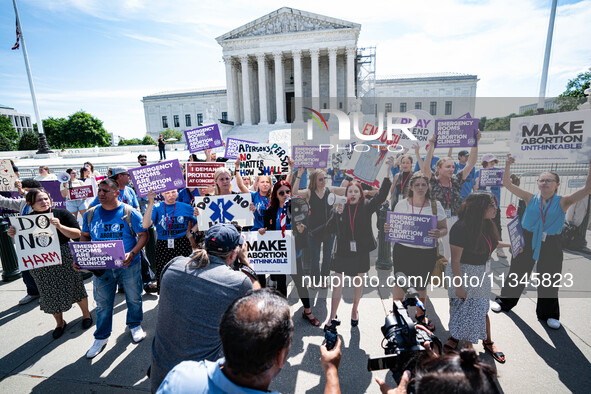 About a dozen pro-life activists are gathering outside the US Supreme Court in Washington, DC, on June 20, 2024, as they await a decision in...