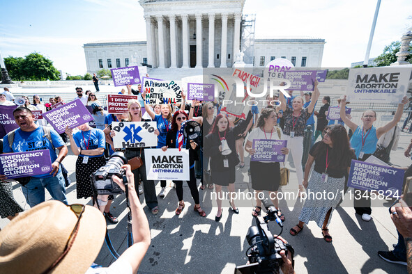 About a dozen pro-life activists are gathering outside the US Supreme Court in Washington, DC, on June 20, 2024, as they await a decision in...