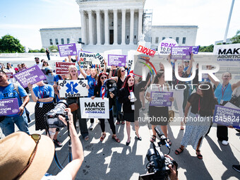 About a dozen pro-life activists are gathering outside the US Supreme Court in Washington, DC, on June 20, 2024, as they await a decision in...