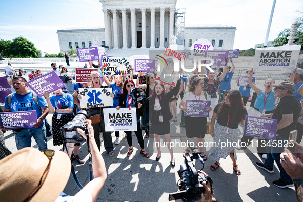 About a dozen pro-life activists are gathering outside the US Supreme Court in Washington, DC, on June 20, 2024, as they await a decision in...