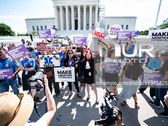 About a dozen pro-life activists are gathering outside the US Supreme Court in Washington, DC, on June 20, 2024, as they await a decision in...