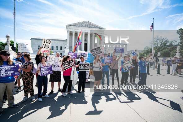 About a dozen pro-life activists are gathering outside the US Supreme Court in Washington, DC, on June 20, 2024, as they await a decision in...