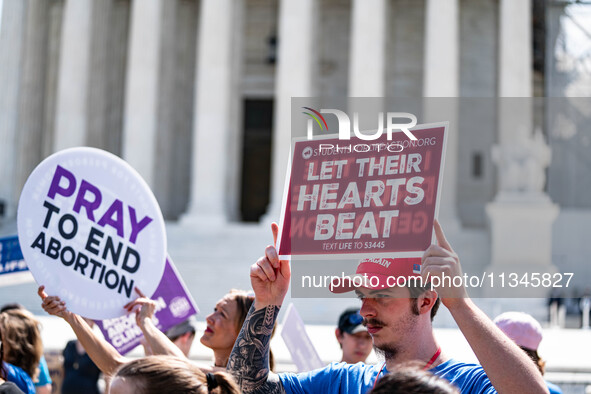 About a dozen pro-life activists are gathering outside the US Supreme Court in Washington, DC, on June 20, 2024, as they await a decision in...