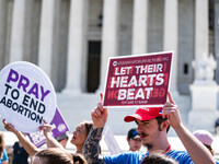 About a dozen pro-life activists are gathering outside the US Supreme Court in Washington, DC, on June 20, 2024, as they await a decision in...