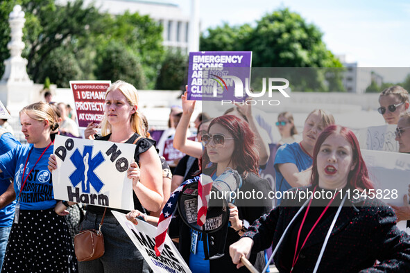 About a dozen pro-life activists are gathering outside the US Supreme Court in Washington, DC, on June 20, 2024, as they await a decision in...