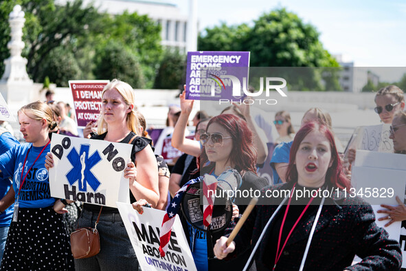 About a dozen pro-life activists are gathering outside the US Supreme Court in Washington, DC, on June 20, 2024, as they await a decision in...