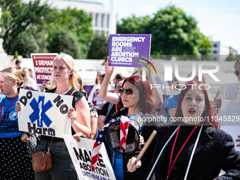 About a dozen pro-life activists are gathering outside the US Supreme Court in Washington, DC, on June 20, 2024, as they await a decision in...