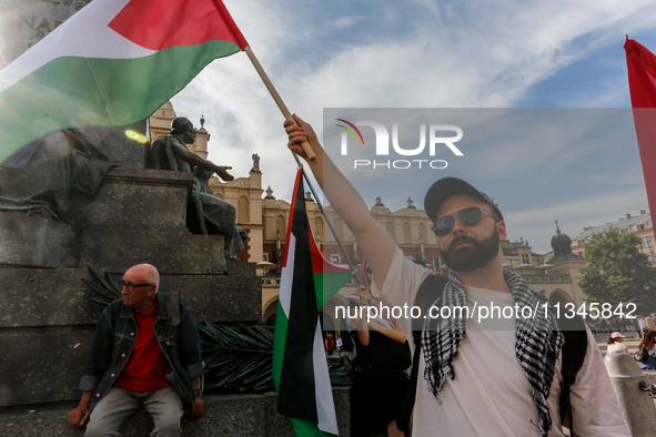 Palestinians and their supporters hold a protest on an International Refugee Day in support of Palestine and against Israeli war actions in...