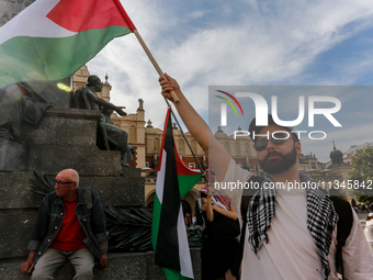 Palestinians and their supporters hold a protest on an International Refugee Day in support of Palestine and against Israeli war actions in...