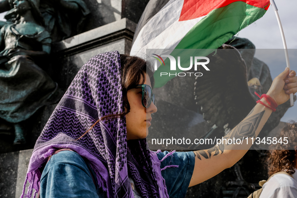 Palestinians and their supporters hold a protest on an International Refugee Day in support of Palestine and against Israeli war actions in...