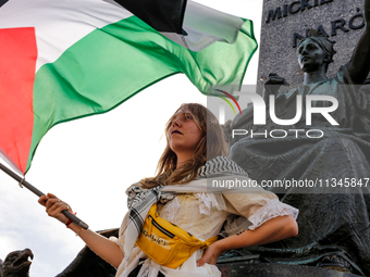 Palestinians and their supporters hold a protest on an International Refugee Day in support of Palestine and against Israeli war actions in...