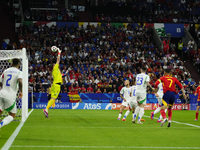 Pedri central midfield of Spain and FC Barcelona shooting to goal and Gianluigi Donnarumma goalkeeper of Italy and Paris Saint-Germain makes...