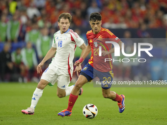 Pedri central midfield of Spain and FC Barcelona and Nicolo Barella central midfield of Italy and Inter Milan compete for the ball during th...