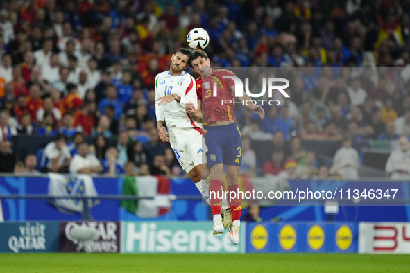 Robin Le Normand centre-back of Spain and Real Sociedad and Lorenzo Pellegrini attacking midfield of Italy and AS Roma compete for the ball...