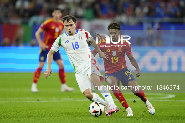 Lamine Yamal right winger of Spain and FC Barcelona and Nicolo Barella central midfield of Italy and Inter Milan during the UEFA EURO 2024 g...