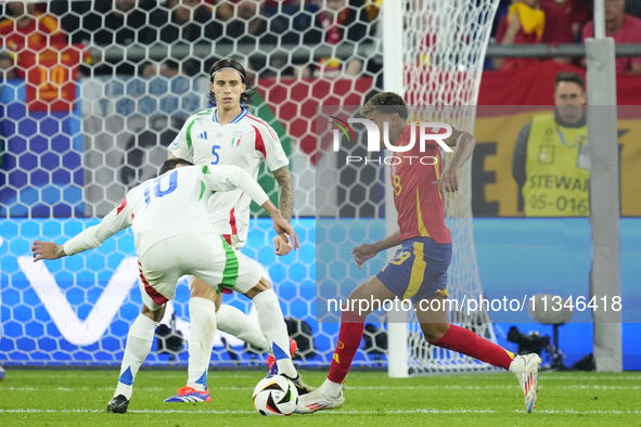 Lamine Yamal right winger of Spain and FC Barcelona in action during the UEFA EURO 2024 group stage match between Spain and Italy at Arena A...