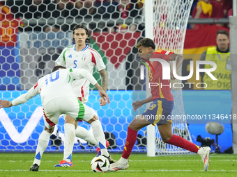 Lamine Yamal right winger of Spain and FC Barcelona in action during the UEFA EURO 2024 group stage match between Spain and Italy at Arena A...