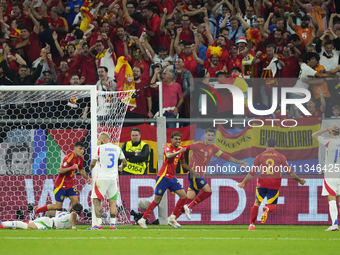 Spanish players celebrate after scoring his sides first goal during the UEFA EURO 2024 group stage match between Spain and Italy at Arena Au...