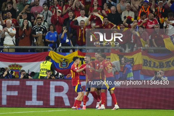 Spanish players celebrate after scoring his sides first goal during the UEFA EURO 2024 group stage match between Spain and Italy at Arena Au...