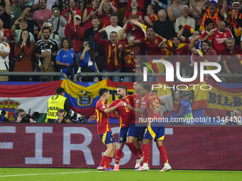 Spanish players celebrate after scoring his sides first goal during the UEFA EURO 2024 group stage match between Spain and Italy at Arena Au...