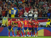 Spanish players celebrate after scoring his sides first goal during the UEFA EURO 2024 group stage match between Spain and Italy at Arena Au...