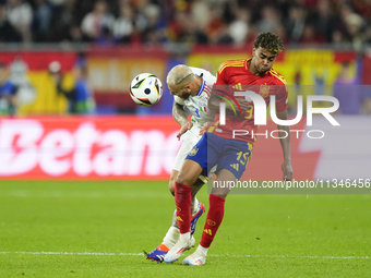 Federico Dimarco left-back of Italy and Inter Milan and Lamine Yamal right winger of Spain and FC Barcelona compete for the ball during the...