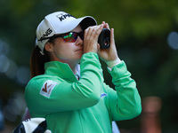 Leone Maguire of Ireland looks through a range finder on the 16th hole during Day One of the KPMG Women's PGA Championship at Sahalee Countr...