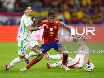 Lamine Yamal right winger of Spain and FC Barcelona and Nicolo Barella central midfield of Italy and Inter Milan compete for the ball during...