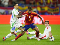 Lamine Yamal right winger of Spain and FC Barcelona and Nicolo Barella central midfield of Italy and Inter Milan compete for the ball during...